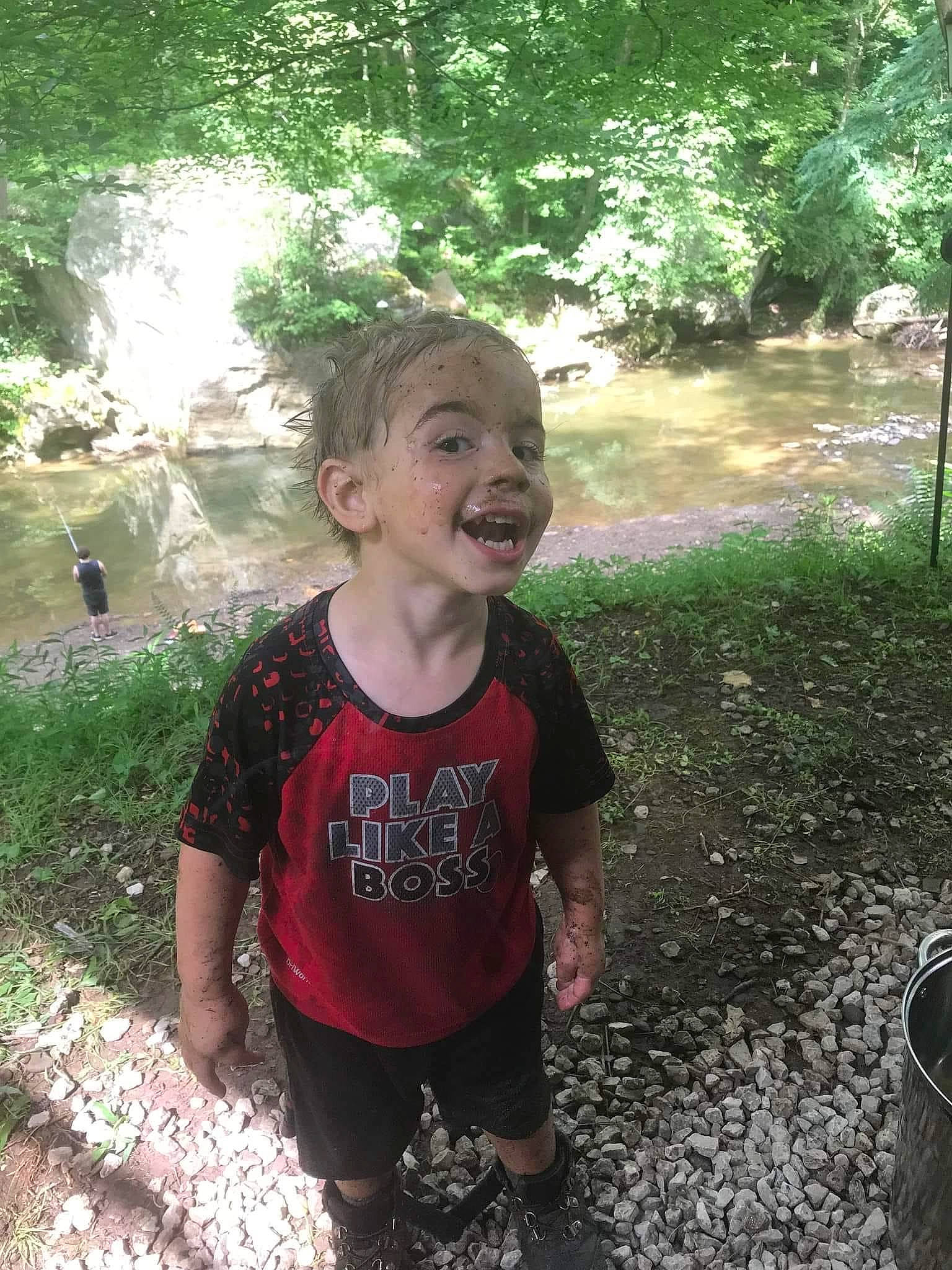 Braxtin is registered to the contest to win money with this photo: botany, child, fun, grass, happy, landscape, leaf, leisure, nature, person, plant, recreation, shorts, smile, stream, summer, t_shirt, toddler, tree, water