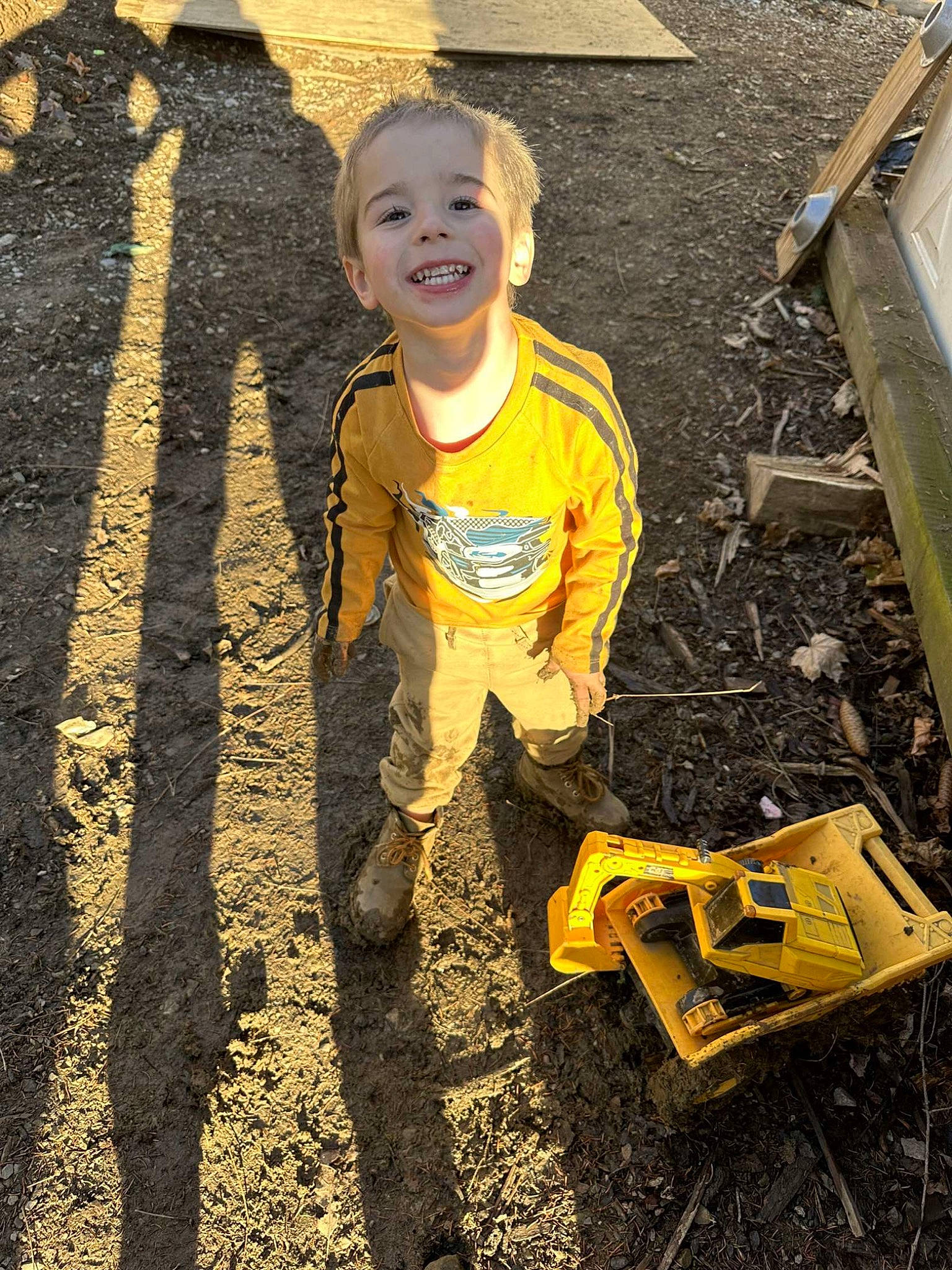 Braxtin is registered to the contest to win money with this photo: asphalt, child, city, flooring, fun, grass, happy, head, joy, landscape, people_in_nature, person, play, road_surface, shadow, sitting, smile, soil, t_shirt, tints_and_shades
