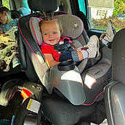 Madalynn is registered to the contest to win money with this photo: blanket, car_interior, car_seat, child, daylight, face_paint, footwear, hair, happy, interior, person, pigtails, red_shirt, seat_belt, sleeping_child, smile, sneakers, toddler, vehicle, window