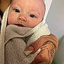 Lila is registered to the contest to win money with this photo: arm, baby, bathtowel, blanket, bodypart, face, finger, hand, happy, head, newborn, person, photography, portrait, quilt, skin, smile, tattoo, towel, wrist