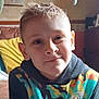 Alfie is registered to the contest to win money with this photo: baby, bed, bedroom, clothing, couch, face, furniture, happy, head, indoors, knitwear, pants, person, photoframe, photography, portrait, room, smile, sweater, t_shirt