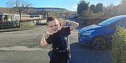 Alfie is registered to the contest to win money with this photo: boy, car, child, city, clothing, face, head, machine, male, outdoors, person, photography, portrait, road, street, t_shirt, transportation, urban, vehicle, wheel