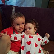 Jaxx joined the competition — help win amazing prizes! child, baby, couch, pillow, heart_pattern, red_clothing, white_clothing, diaper, indoor, cute, siblings, family, portrait, smiling, curious, toddler, cuddling, plush, relaxed, home