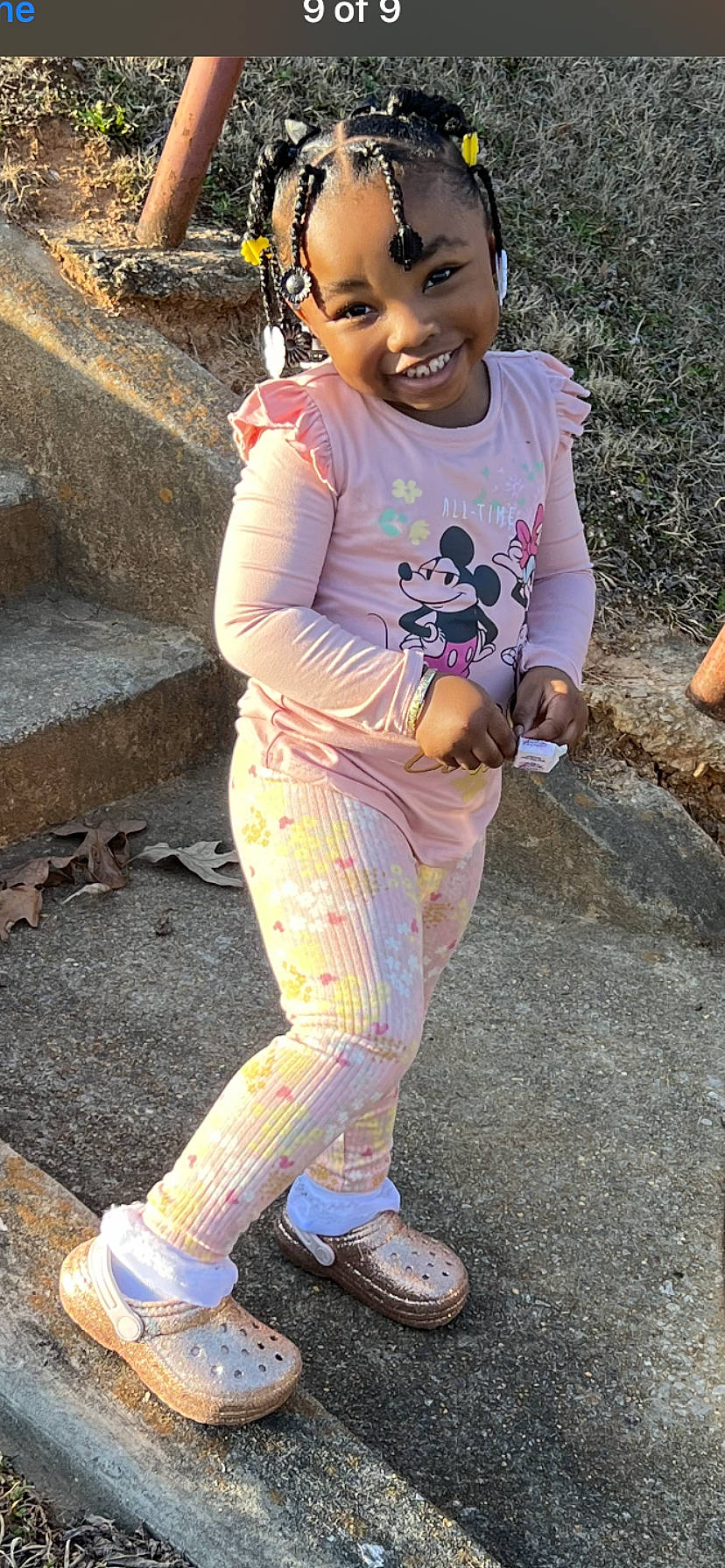 Karli is registered to the contest to win money with this photo: child, fun, happy, head, joy, leisure, magenta, necklace, pattern, person, personal_protective_equipment, pink, recreation, sandal, shoe, sleeve, smile, sneakers, soil, t_shirt