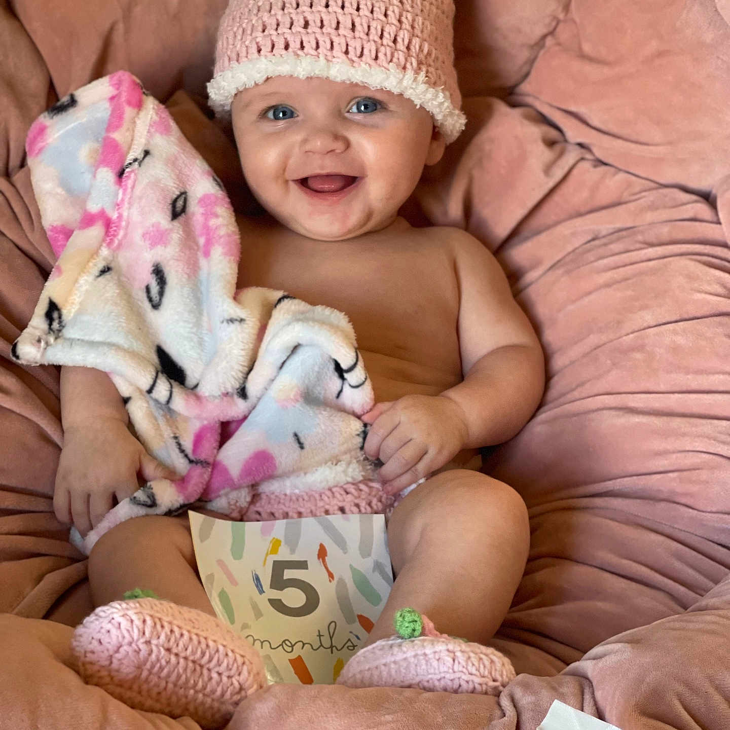 Rosaline joined the competition — help win amazing prizes! baby, blanket, booties, bunny_ears, child, cozy, crocheted_hat, cute, face, feet, hands, happy, indoors, infant, milestone_card, pink_cushion, portrait, sitting, smiling, soft_toy