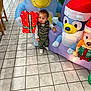 Kyson Orr joined the competition — help win amazing prizes! child, toddler, inflatable, holiday_decor, gift, floor_tile, indoor, animal_figure, present, smiling, colorful, clothing, vest, shoes, curious, standing, decoration, fun, festive, toy