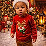 candy_cane, child, christmas_hat, christmas_lights, christmas_tree, cute, festive, fireplace, holiday_cheer, holiday_decor, holiday_season, indoors, lantern, portrait, red_sweater, reindeer_design, snowy_floor, toddler, winter, wrapped_presents