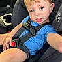 Mason is registered to the contest to win money with this photo: toddler, child, car_seat, blue_shirt, seatbelt, car_interior, blond_hair, reaching_hand, curious_expression, baby, safety_harness, vehicle, seat, young_child, person, infant, casual_clothing, travel, portrait, indoors