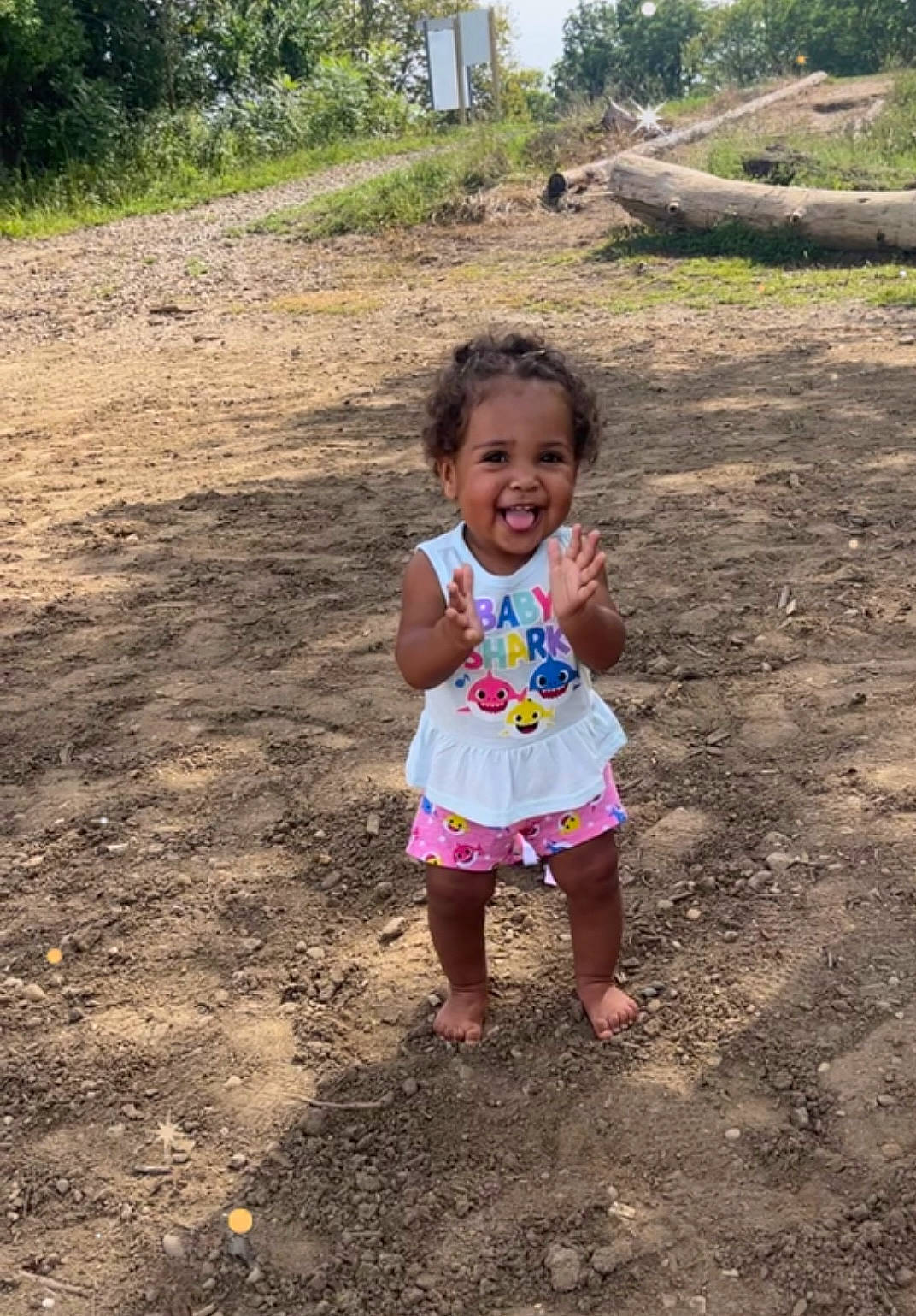 Jaelynn is registered to the contest to win money with this photo: asphalt, child, dress, fun, grass, happy, landscape, leisure, people_in_nature, person, plant, play, recreation, road, sand, smile, soil, toddler, travel, tree