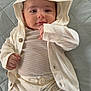 Hamed joined the competition — help win amazing prizes! baby, infant, hood, clothing, cute, lying_down, quilt, bed, pajamas, smile, face, hands, eyes, child, person, soft, comfortable, home, portrait, young