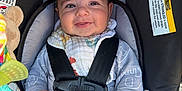 Hamed joined the competition — help win amazing prizes! baby, car_seat, smile, blanket, straps, toy, child, clothing, happy, infant, face, hand, sitting, cute, portrait, indoors, safety, comfort, young, expression
