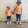 Kaydine participe au concours pour gagner de l'argent avec cette photo : child, children, holding_hands, matching_clothes, bucket_hats, smiling, shorts, sneakers, outdoor, wall, concrete, texture, person, casual, summer, happy, friends, portrait, standing, fashion