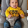 Ayani participe au concours pour gagner de l'argent avec cette photo : baby, child, smiling, yellow_shirt, denim_jeans, baby_seat, gray_cushion, happy, portrait, infant, cute, clothing, fabric, seated, indoor, person, face, joyful, casual, small_hand