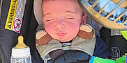 Jasper is registered to the contest to win money with this photo: baby, car_seat, sleeping, child, bottle, plush_toy, fan, blanket, seatbelt, comfort, infant, clothing, headrest, safety, resting, indoors, cute, peaceful, nap, young_child
