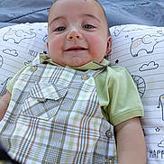 Jasper joined the competition — help win amazing prizes! baby, child, smile, face, clothing, overalls, pillow, pattern, elephant, cloud, green_shirt, infant, cute, young_child, happy, closeup, portrait, lying_down, outdoor, soft_light
