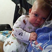 Kairee joined the competition — help win amazing prizes! baby, child, adult, pajamas, animal_print, indoor, portrait, person, clothing, face, expression, comfort, holding, bedroom, blanket, painting, wall, hair, blue_shirt, together