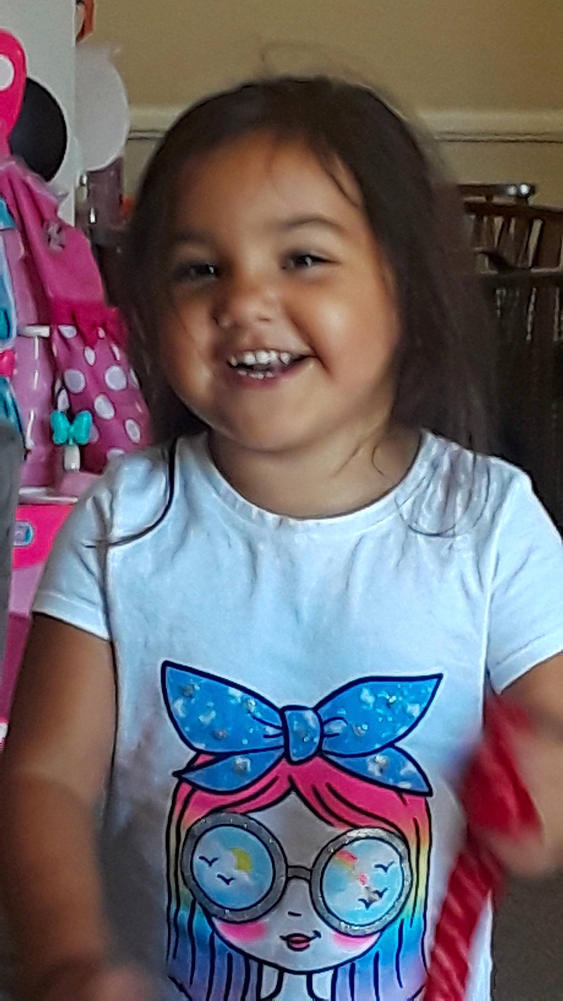 Gabriella is registered to the contest to win money with this photo: black_hair, butterfly, cheek, child, cool, ear, face, fun, happy, head, iris, joy, laugh, neck, nose, person, play, smile, t_shirt, toddler