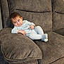 Jahan is registered to the contest to win money with this photo: baby, carpet, casual, child, comfort, couch, cozy, curious, furniture, gray, home, indoor, infant, looking_away, pajamas, person, plush, relaxing, seated, young_child
