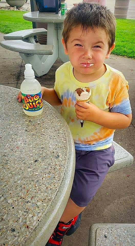 Phoenix is registered to the contest to win money with this photo: bottle, bottle_cap, bottled_water, child, drink, drinkware, finger, green, happy, leisure, person, plastic_bottle, shorts, sleeve, t_shirt, thumb, tin_can, toddler, water_bottle, white