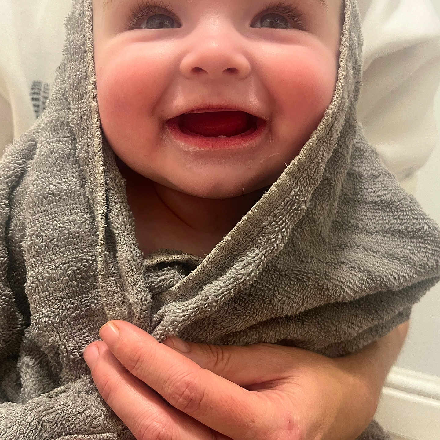 Elianna is registered to the contest to win money with this photo: accessories, baby, babylaughing, blanket, bodypart, clothing, face, finger, hand, happy, head, hood, jewelry, laughing, person, photography, portrait, ring, smile, towel