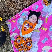 Aurora is registered to the contest to win money with this photo: baby, blanket, child, costume, cute, fall, flowers, halloween, hat, hay, headwear, holiday, infant, nature, outdoor, patterned_clothing, pink, resting, sleeping, striped_socks