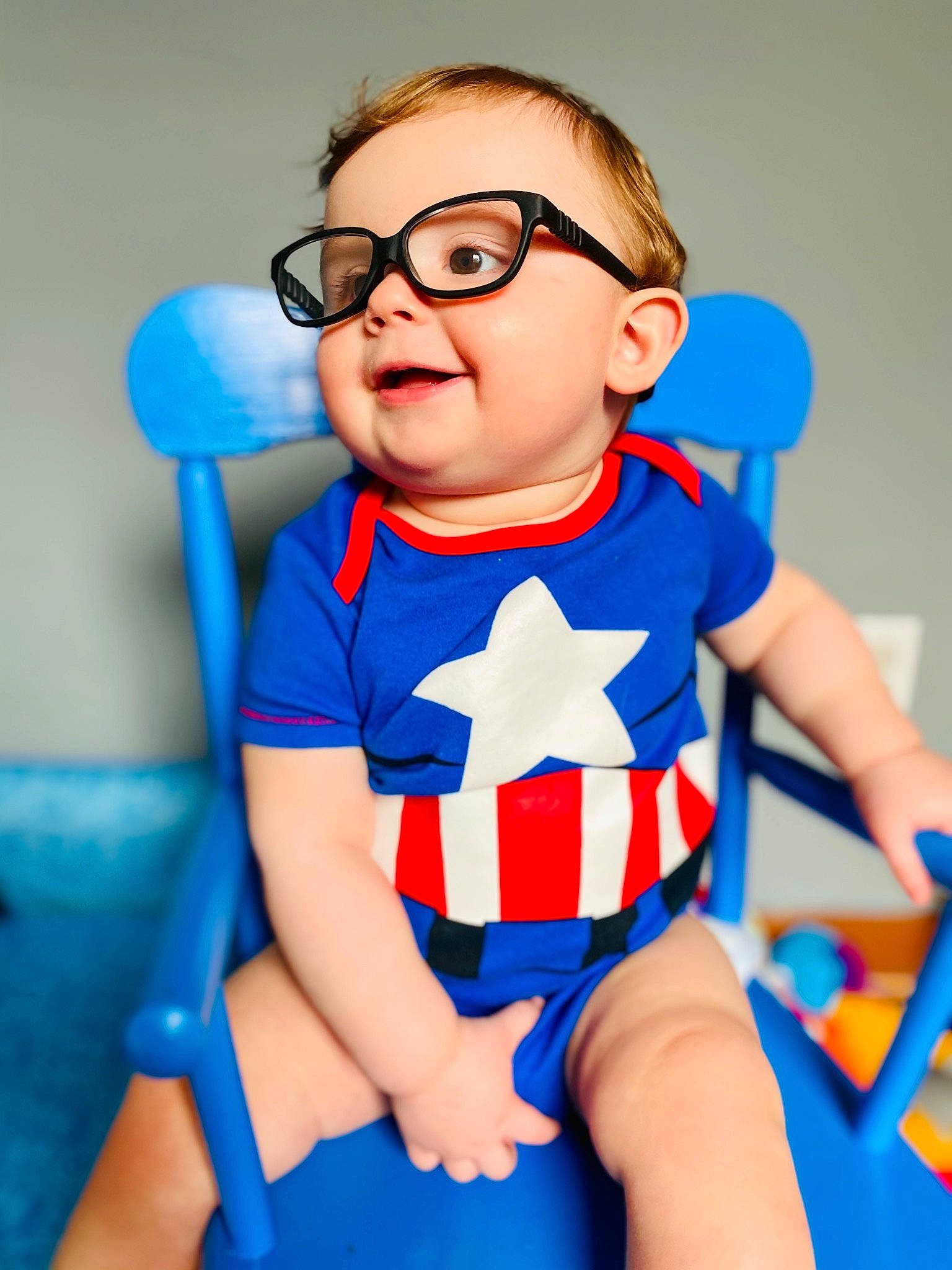 Carter James is registered to the contest to win money with this photo: azure, baby_toddler_clothing, blue, eye, face, finger, gesture, glasses, hairstyle, happy, head, human_body, joint, mouth, neck, organ, person, skin, thigh, thumb