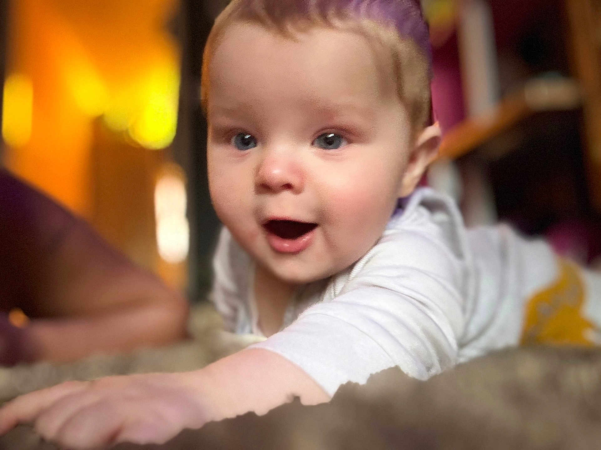 Albie-James joined the competition — help win amazing prizes! baby, infant, face, blue_eyes, hand, white_clothing, crawling, indoor, soft_light, blurred_background, curious, child, person, closeup, skin, young, cute, expression, portrait, warm_colors