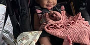 Milani joined the competition — help win amazing prizes! baby, car_seat, yellow_bow, blanket, pink_blanket, smiling, infant, child, seatbelt, car_interior, cute, portrait, clothing, person, foot, fabric, travel, happy, seat, vehicle