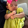 Milani joined the competition — help win amazing prizes! baby, sleeping, pink_bow, yellow_dress, infant, child, person, arms, closeup, peaceful, cute, indoor, portrait, clothing, headband, soft_lighting, skin, hand, resting, toddler