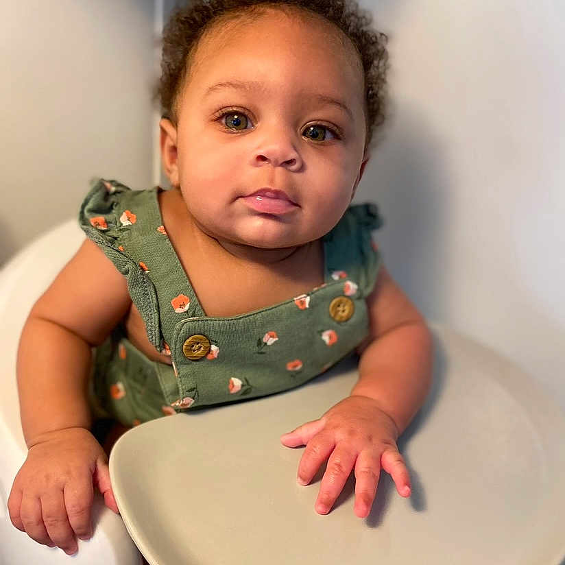 Avaya Miracle is registered to the contest to win money with this photo: baby, bodypart, chair, cutlery, face, finger, food, fork, furniture, hand, happy, head, indoors, meal, person, photography, portrait, sitting, smile, table