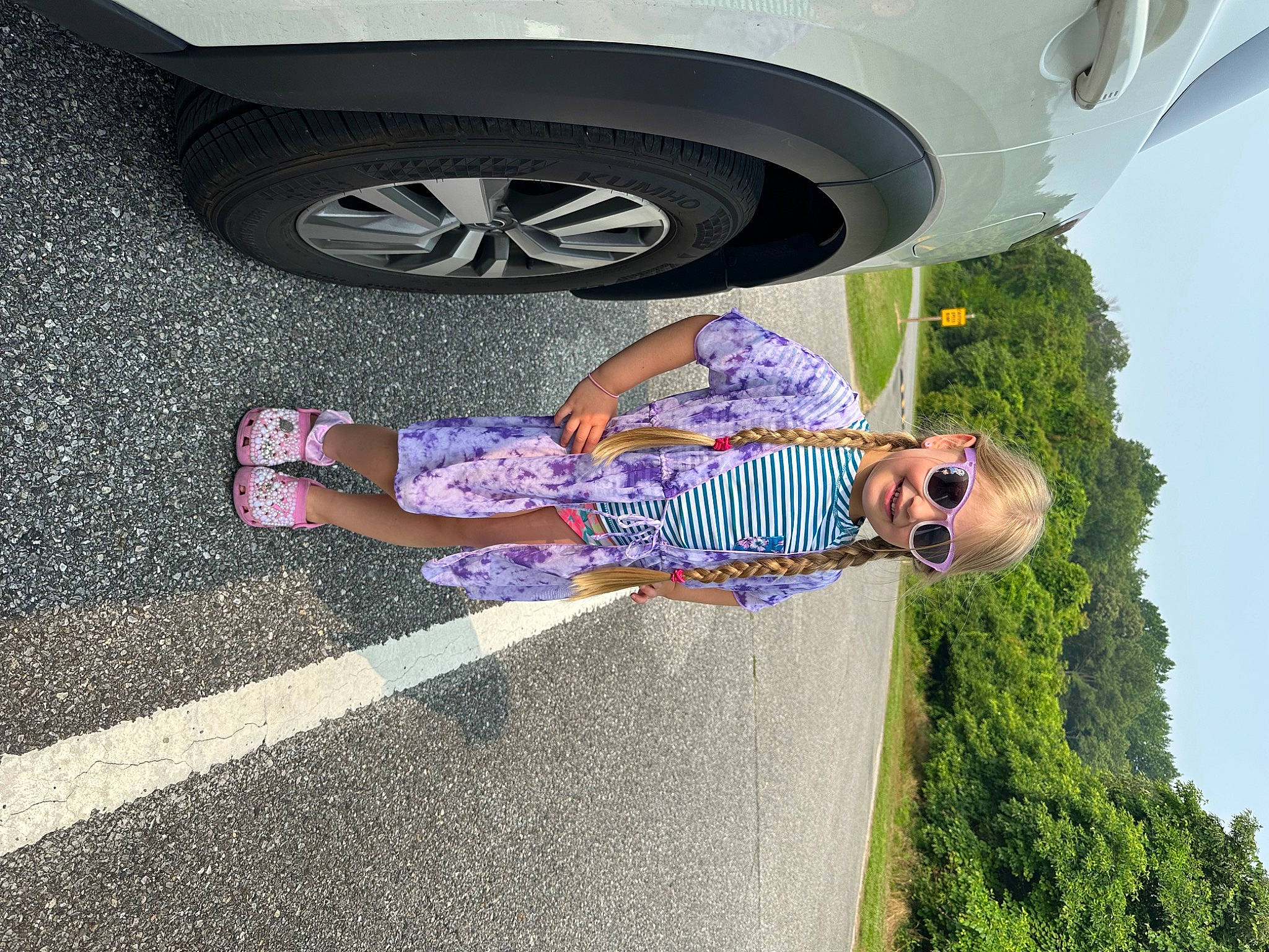 Adriana is registered to the contest to win money with this photo: asphalt, automotive_exterior, automotive_lighting, automotive_tire, car, fender, joy, light, motor_vehicle, person, photograph, plant, road_surface, sky, sunglasses, tints_and_shades, tire, tree, vehicle, vehicle_door