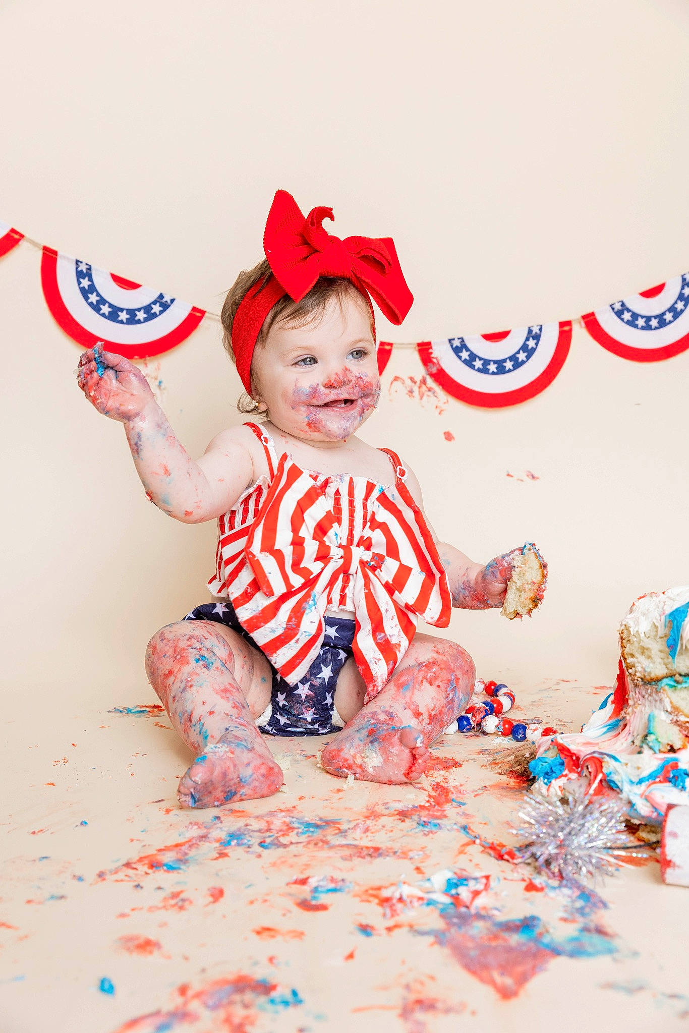 Isabella is registered to the contest to win money with this photo: baby, baby_toddler_clothing, ball, carmine, child, event, facial_expression, fictional_character, fun, happy, headgear, holiday, joy, party_supply, pattern, person, play, sitting, sleeve, smile