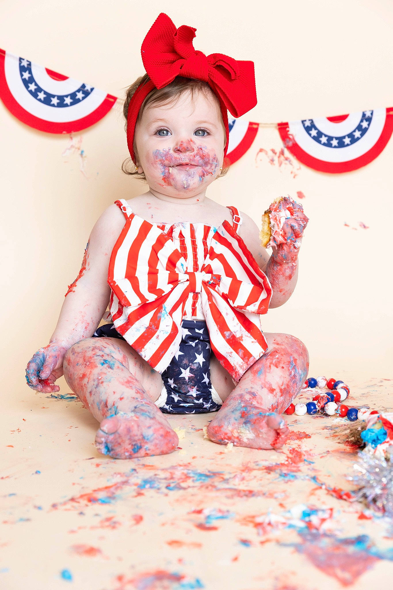 Isabella is registered to the contest to win money with this photo: baby, baby_toddler_clothing, carmine, child, costume_hat, event, fictional_character, fun, happy, holiday, logo, party_supply, pattern, person, portrait_photography, red, sitting, sleeve, smile, t_shirt