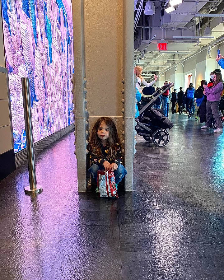 Lily is registered to the contest to win money with this photo: automotive_design, automotive_tire, baby_carriage, baby_products, beauty, boot, city, event, floor, flooring, fun, leisure, magenta, person, public_space, purple, sitting, standing, tire, toddler