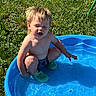 toddler, child, pool, water, blue, grass, outdoor, splash, summer, sunlight, green, footwear, play, happy, bare_chested, daytime, nature, young_child, casual, recreation