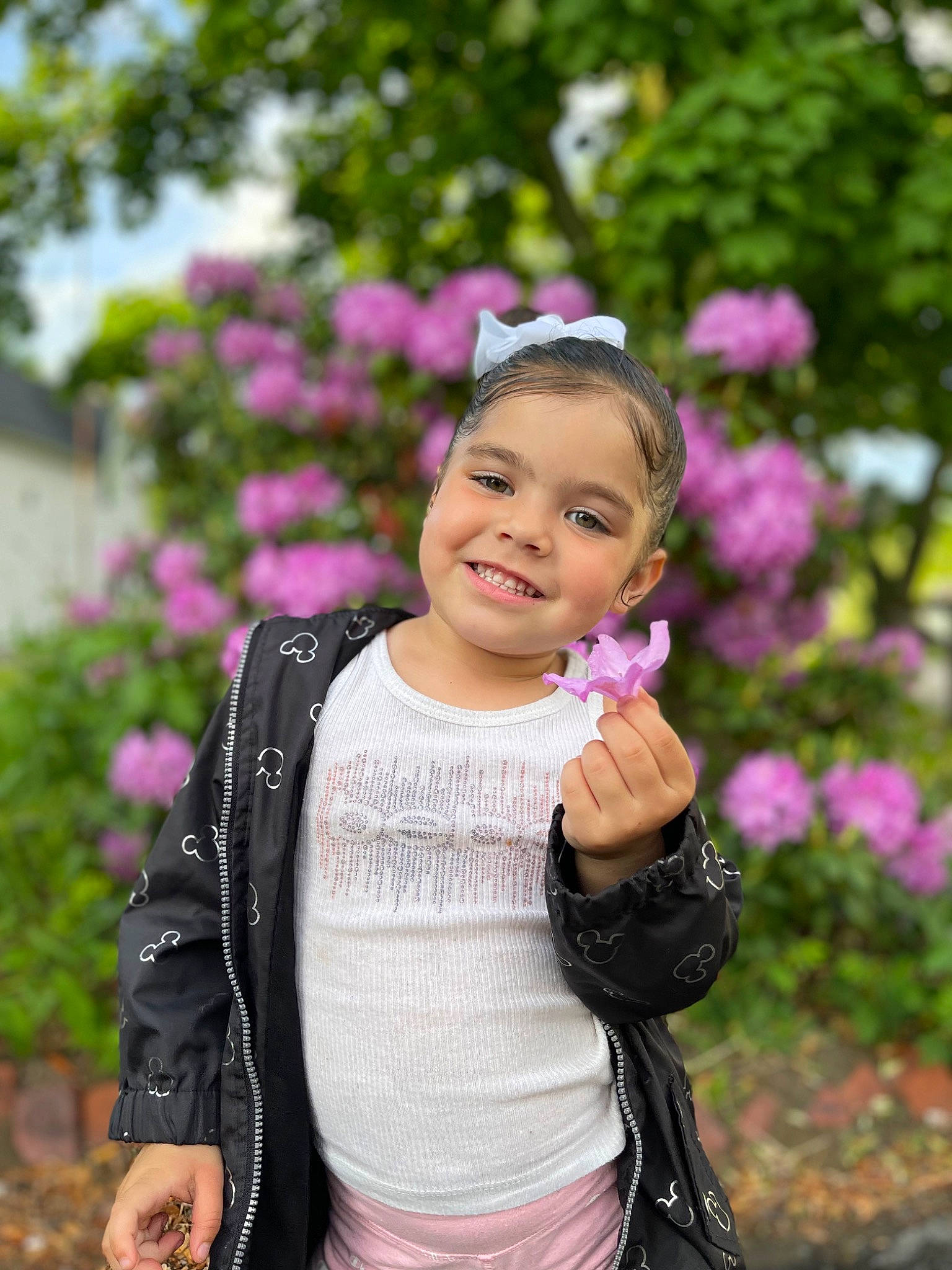 Leylani joined the competition — help win amazing prizes! black_hair, face, flower, grass, hair, happy, head, iris, joy, leisure, lip, magenta, people_in_nature, person, petal, pink, plant, recreation, sleeve, street_fashion