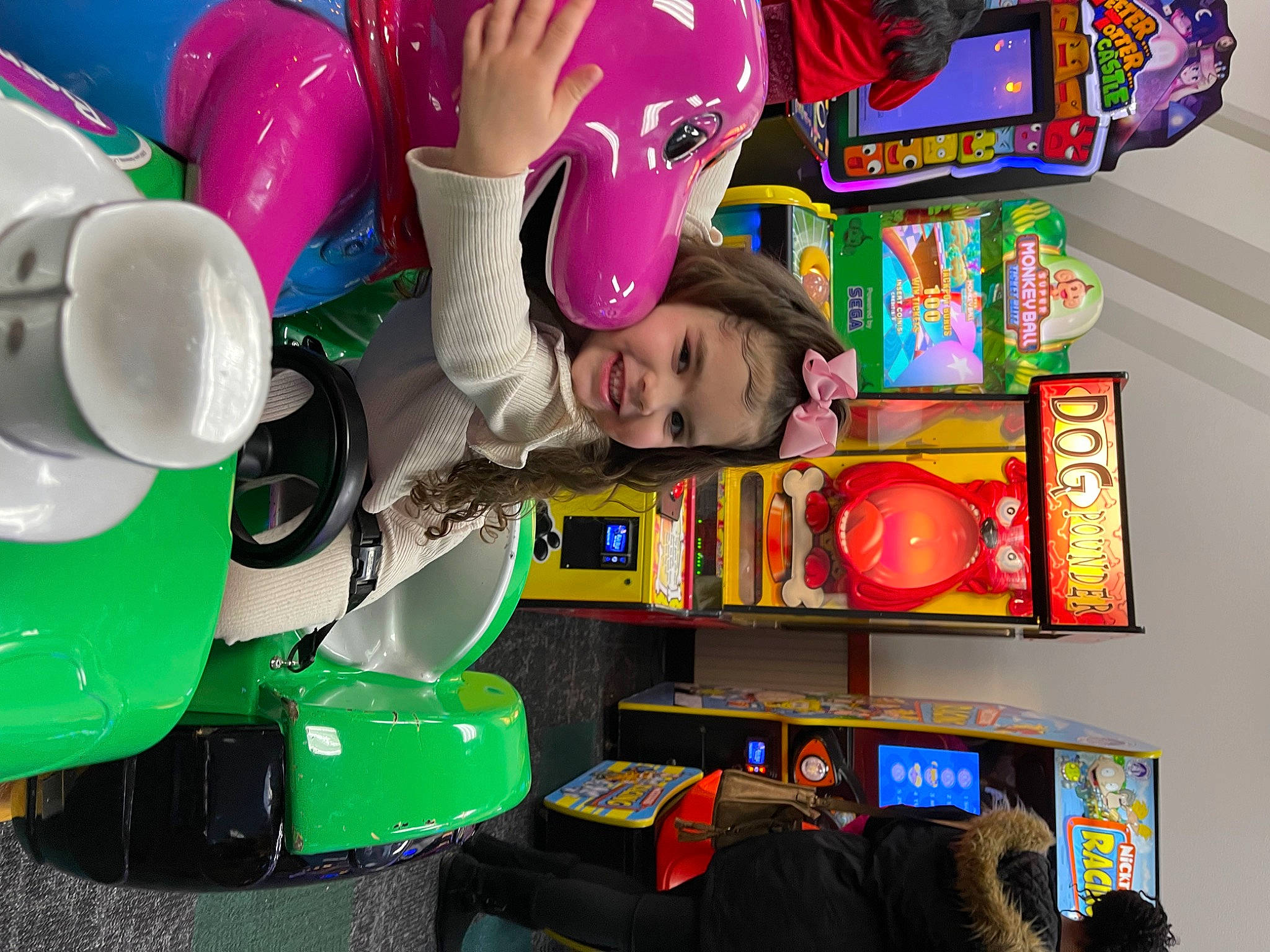 Leylani is registered to the contest to win money with this photo: balloon, child, customer, event, fun, green, happy, joy, leisure, machine, magenta, party_supply, person, plastic, recreation, retail, room, shelf, shelving, smile