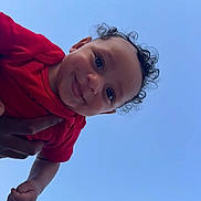 Legend joined the competition — help win amazing prizes! baby, child, curly_hair, smile, red_clothing, blue_sky, happy, face, portrait, outdoor, person, cute, joyful, infant, hand, skin, eyes, head, expression, holding