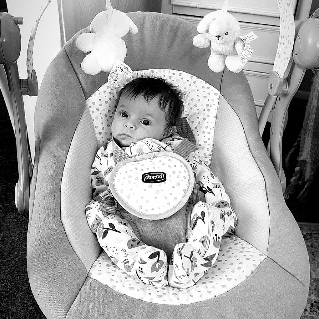 Maggie-Olwen joined the competition — help win amazing prizes! baby, baby_boy, baby_girl, baby_seat, black_and_white, bouncer, carpet, chicco, cute, dressing_table, face, floor_rug, furniture, indoor, infant, patterned_clothing, plush_toys, portrait, room_interior, soft_toys
