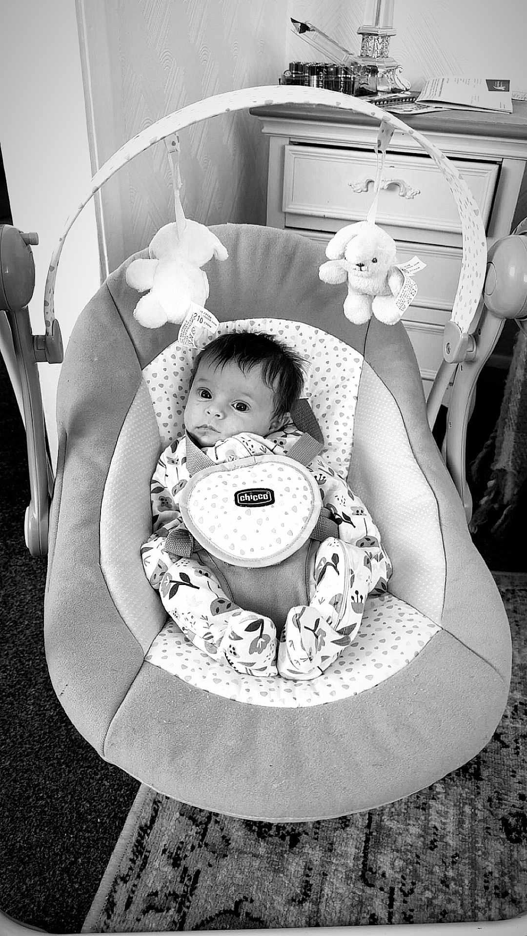 Maggie-Olwen joined the competition — help win amazing prizes! baby, baby_boy, baby_girl, baby_seat, black_and_white, bouncer, carpet, chicco, cute, dressing_table, face, floor_rug, furniture, indoor, infant, patterned_clothing, plush_toys, portrait, room_interior, soft_toys