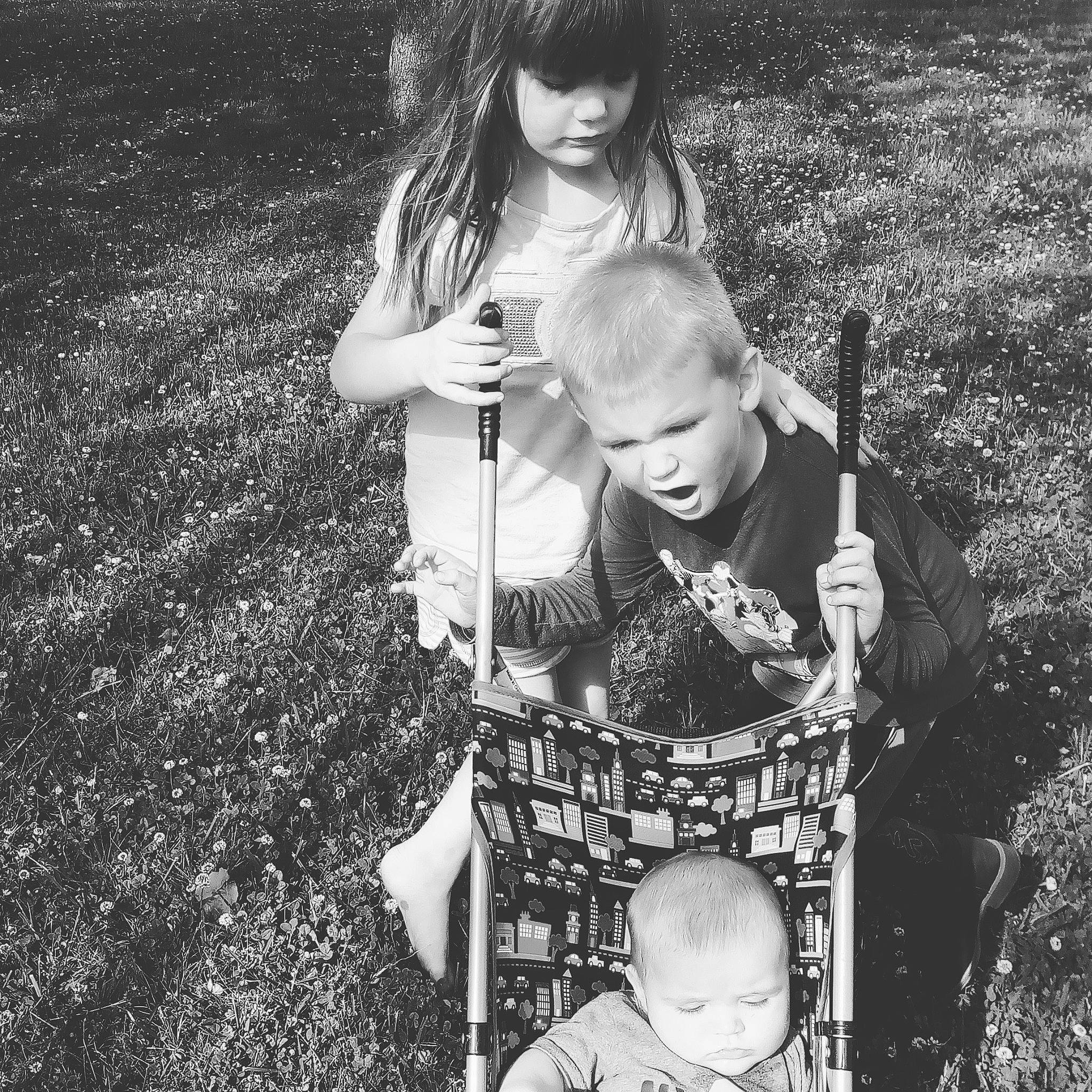 Bridgette joined the competition — help win amazing prizes! arm, black, black_and_white, clothing, facial_expression, flash_photography, grass, hair, hairstyle, happy, head, human, monochrome, person, photograph, plant, shorts, standing, style, toddler