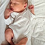newborn, baby, sleeping, infant, white_clothing, blanket, soft_texture, peaceful, cute, resting, skin, hand, foot, face, indoors, closeup, small, young_child, cozy, quiet