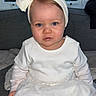 baby, child, girl, white_dress, headband, bow, sitting, indoor, couch, window, curtains, blue_eyes, portrait, cute, infant, clothing, face, person, toddler, home