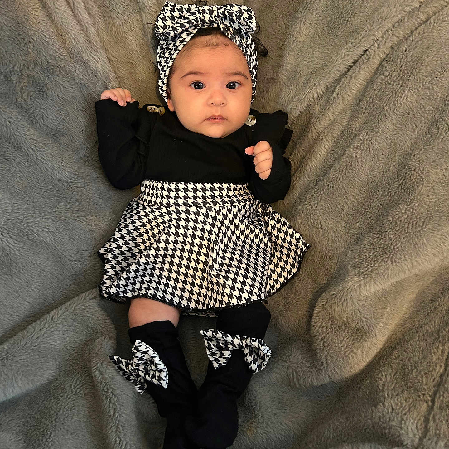 Juliána Bellé joined the competition — help win amazing prizes! baby, baby_fashion, black_and_white, blanket, bow, child, clothing, cute, expression, fashion, headband, houndstooth, indoor, infant, lying_down, person, portrait, sock, soft_texture, young_child