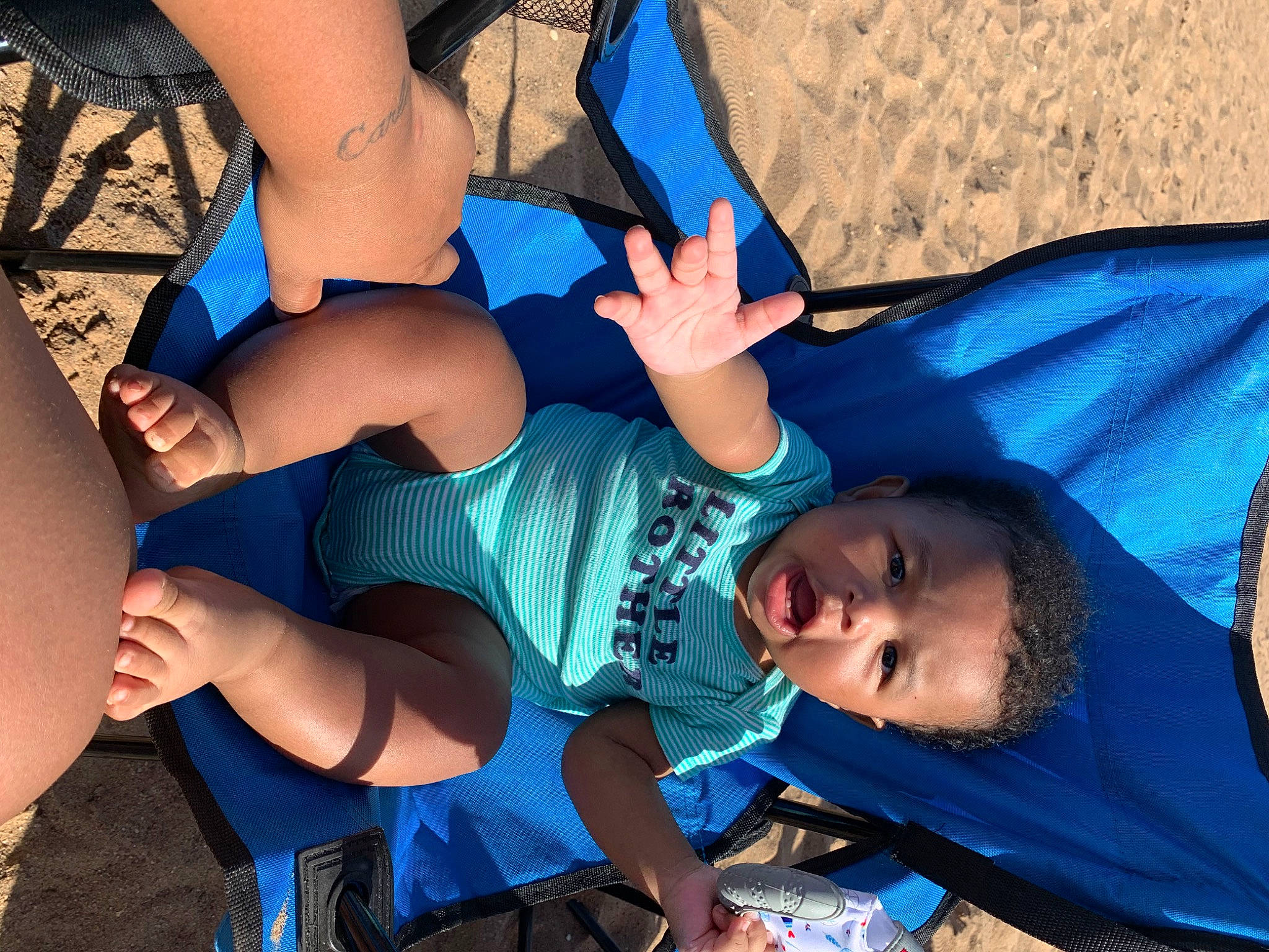 Ayden is registered to the contest to win money with this photo: azure, beach, blue, cool, elbow, electric_blue, facial_expression, foot, friendship, fun, happy, human_leg, interaction, joint, knee, leisure, person, shorts, snapshot, thigh