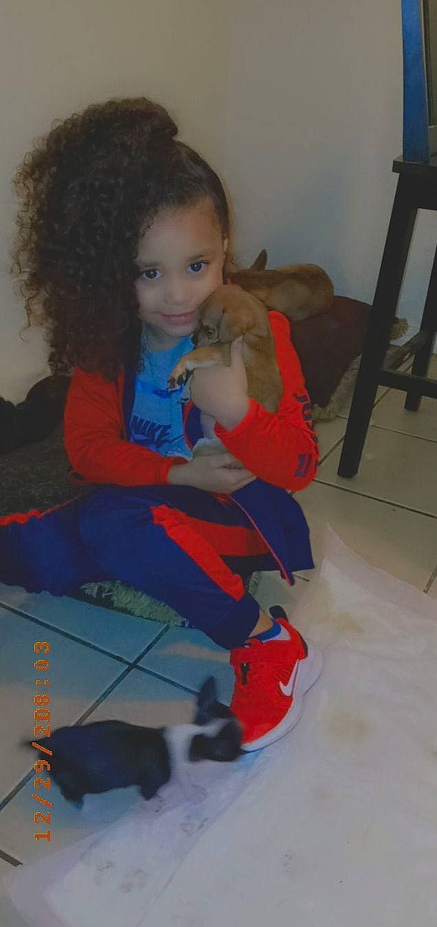 Aniyah joined the competition — help win amazing prizes! chair, child, electric_blue, face, flooring, fun, hairstyle, head, human_leg, joint, joy, knee, lap, person, room, shoe, sitting, sneakers, sock, thigh