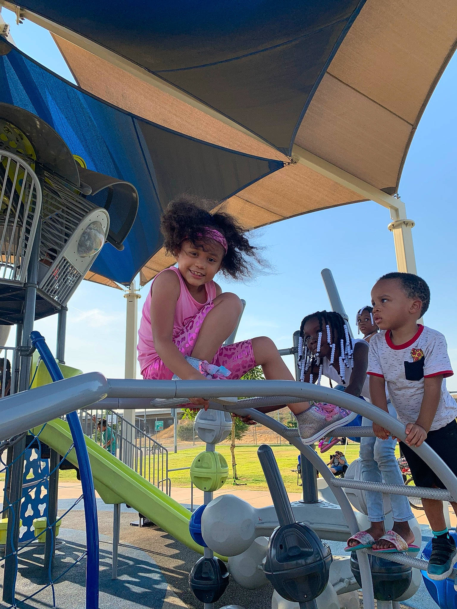 Aniyah is registered to the contest to win money with this photo: blue, child, city, daytime, fun, happy, headwear, joy, leisure, light, person, play, recreation, shade, shorts, sitting, sky, summer, t_shirt, toddler