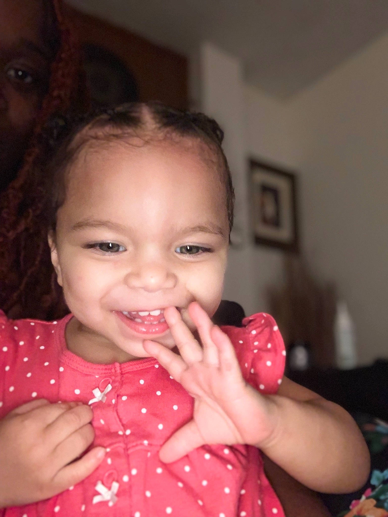 Corina is registered to the contest to win money with this photo: arm, baby, baby_toddler_clothing, cheek, dress, ear, eyelash, finger, gesture, hairstyle, hand, happy, human_body, joy, lip, mouth, nose, person, pink, skin