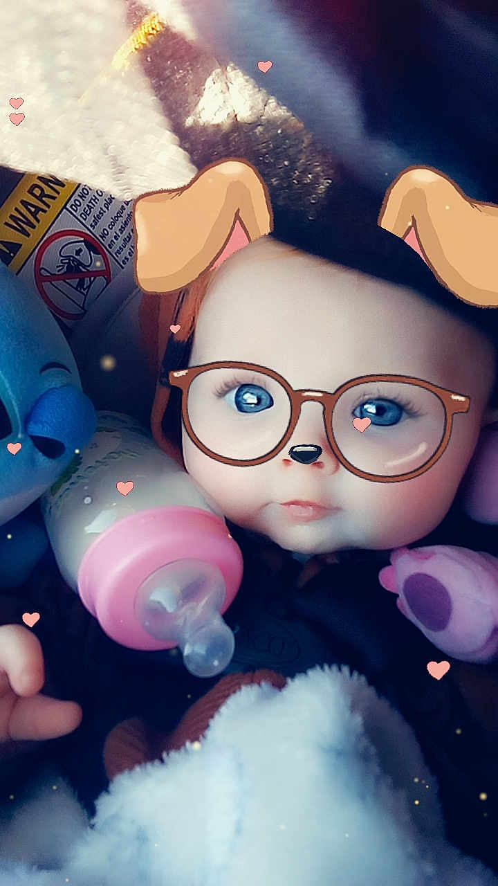 Emerald is registered to the contest to win money with this photo: baby, infant, face, glasses_filter, dog_ears_filter, bottle, toy, plush_toy, blue_eyes, hand, blanket, closeup, cute, digital_filter, heart_shapes, child, indoors, portrait, soft_lighting, baby_clothing
