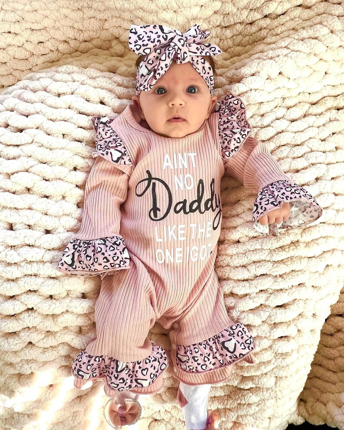 Leighton is registered to the contest to win money with this photo: baby, baby_toddler_clothing, brown_hair, child, cool, face, fashion_accessory, fashion_design, font, hair_accessory, hand, happy, headband, headgear, headwear, jewellery, outerwear, pattern, peach, person